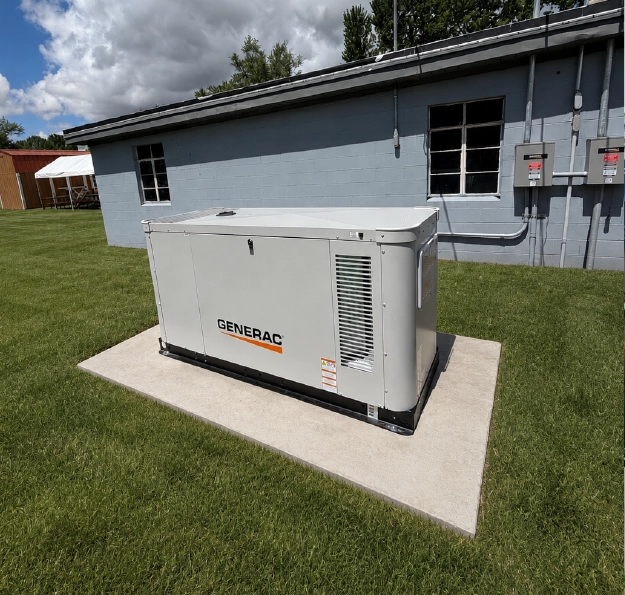 generac-commercial-generator-installation-columbus-oh Generac commercial standby generator installed on a concrete pad outside a Central Ohio building.